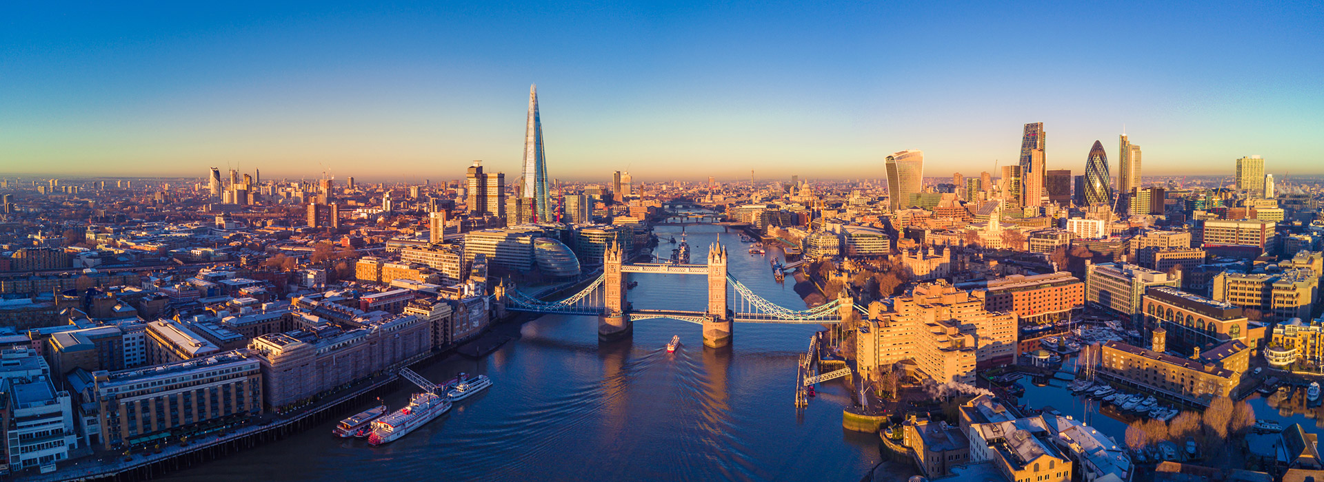 London skyline with Tower Bridge at sunset.